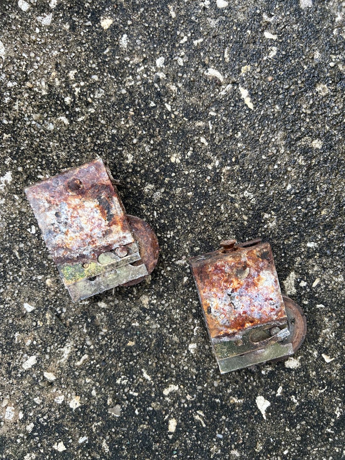 Rusty corroded rollers removed from a sliding door